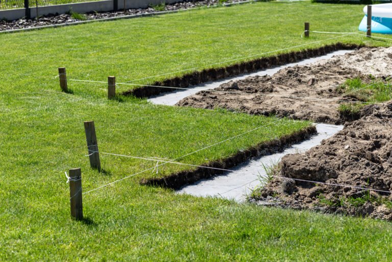 Foundation footings poured in a ditch in the yard, building a terrace in the backyard.